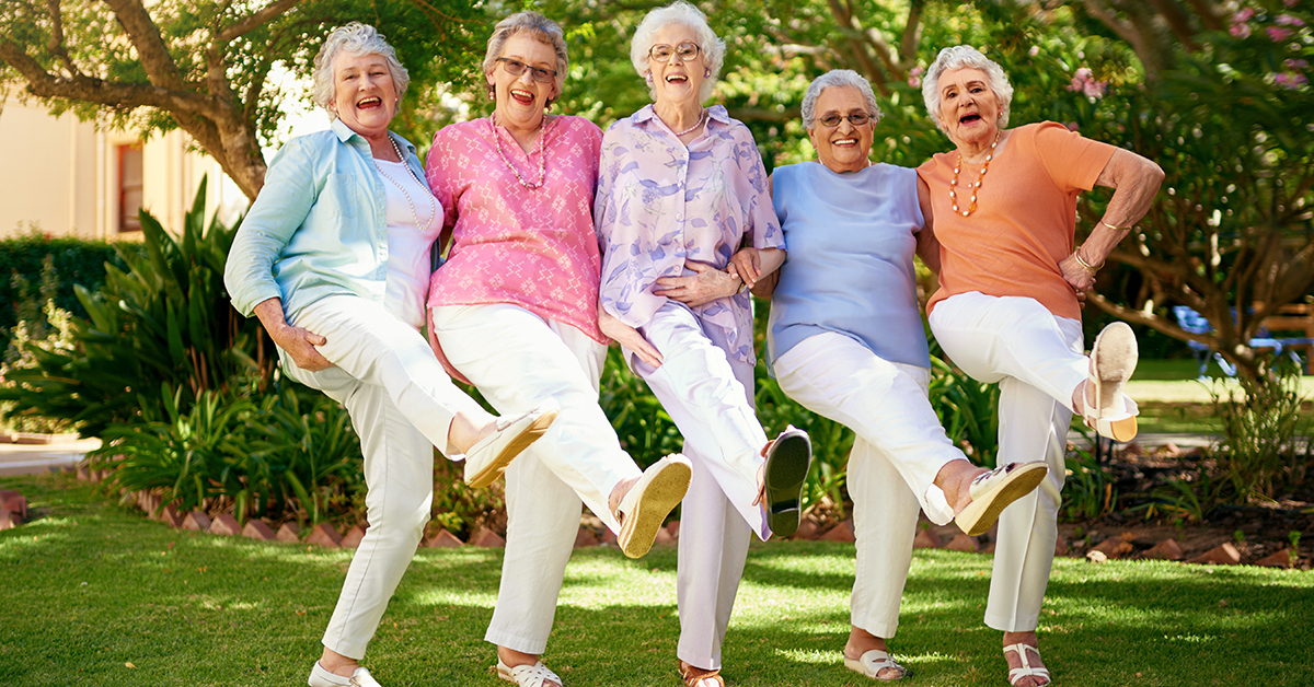 Senior women laughing and doing the can can dance